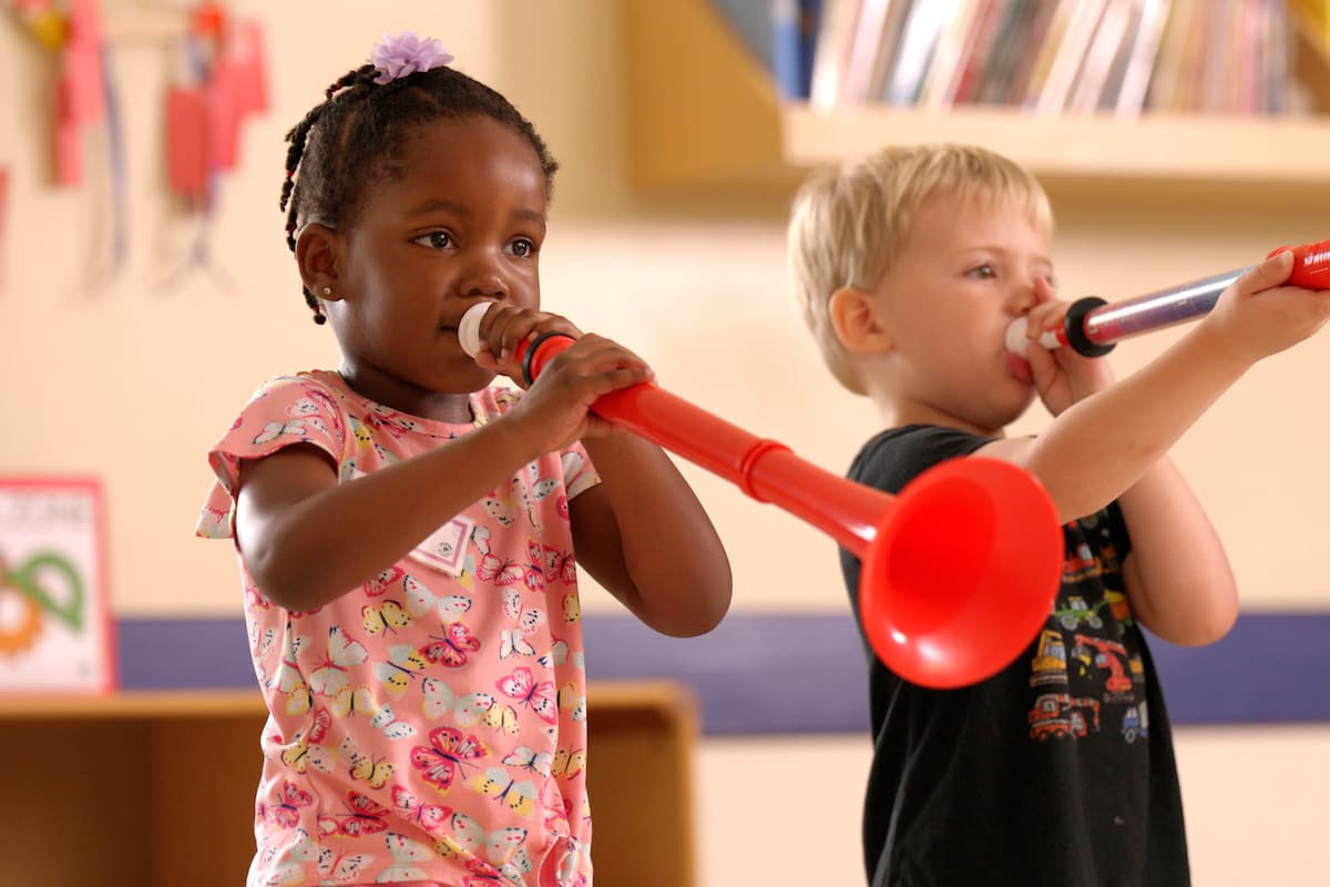 students playing a red horn