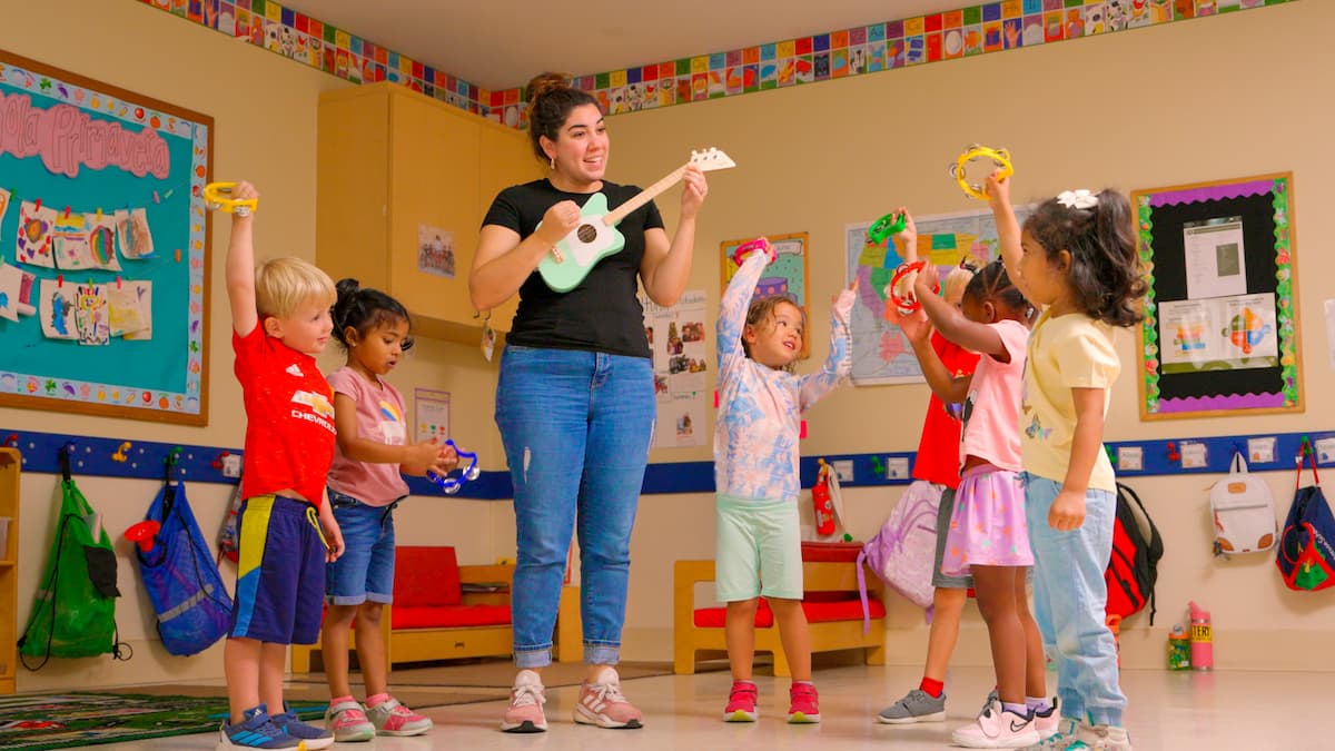 teacher playing music for kids