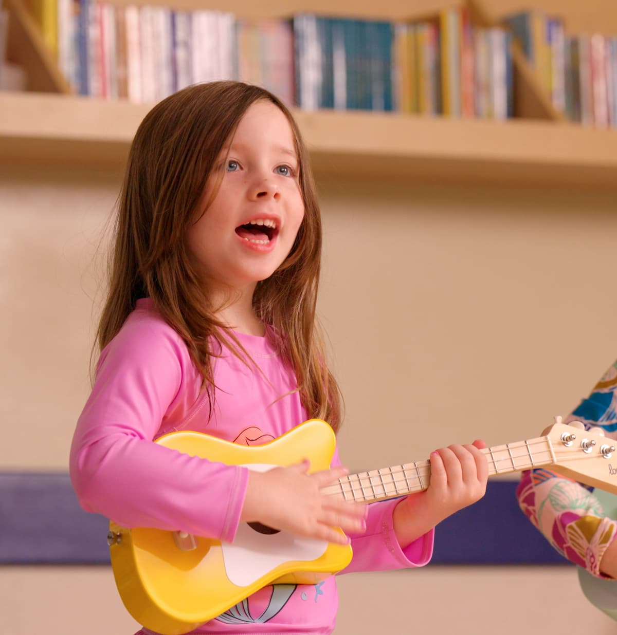 student playing a yellow guitar