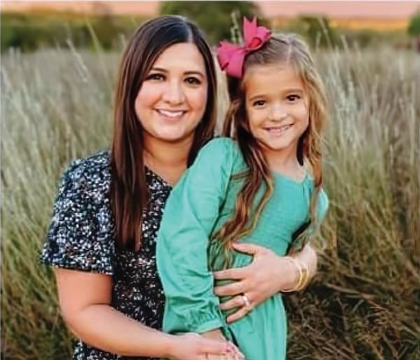 Mother and daughter in a field.